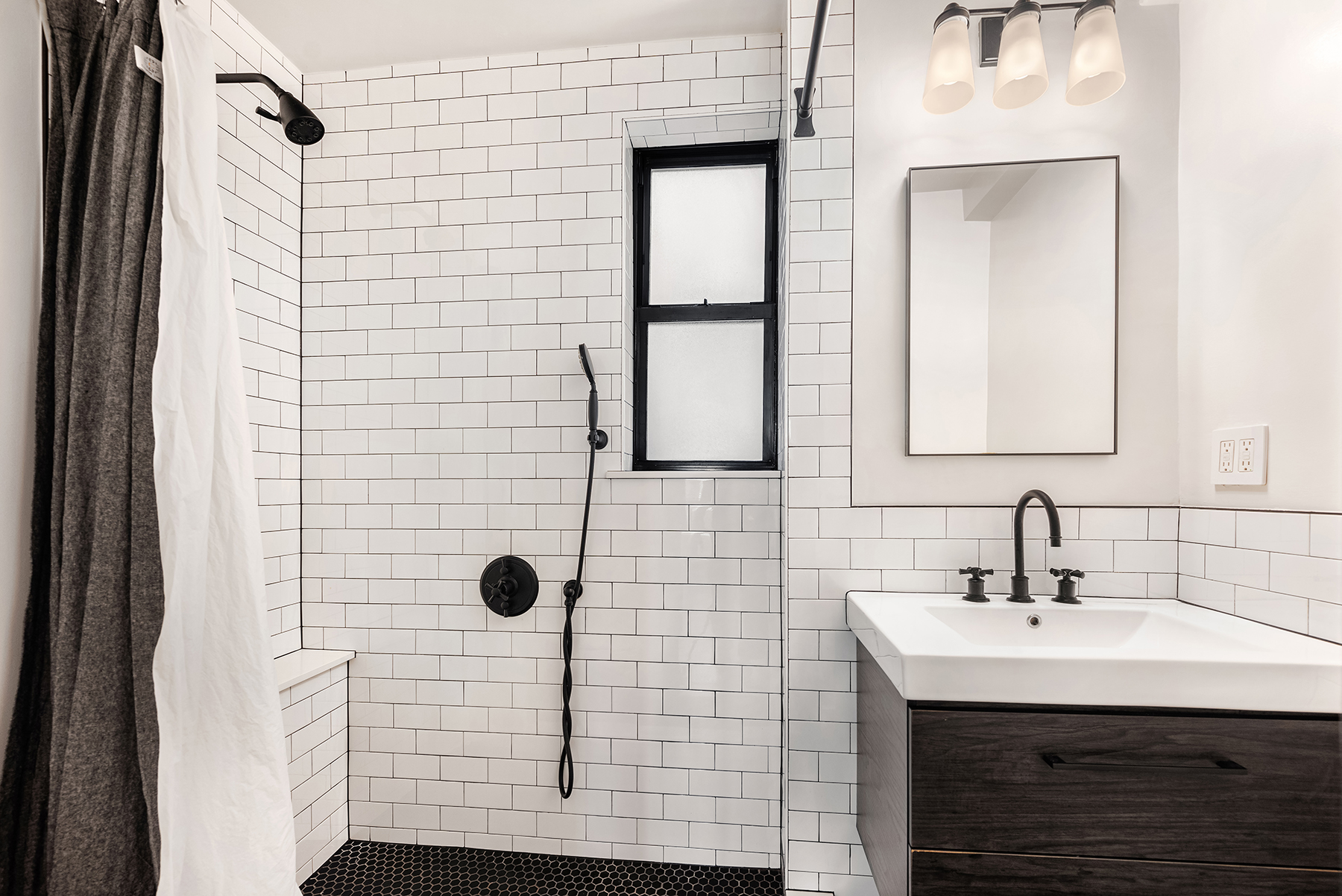 339 East 58th Street, Unit 3J Manhattan, NY 10022 - Photo 5 of 9 a bathroom with a sink and a mirror