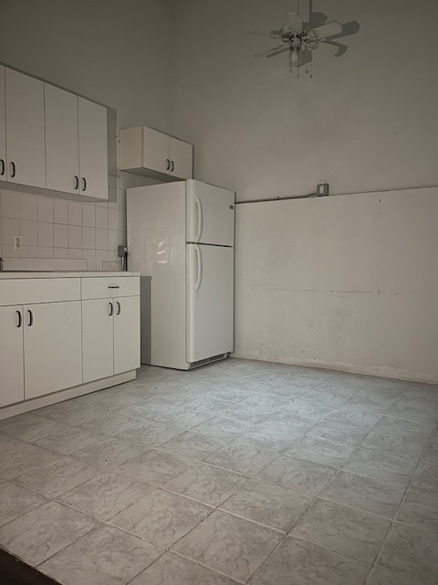 23 2nd Avenue, Unit 4 Manhattan, NY 10003 - Photo 3 of 4 a view of a kitchen with white cabinets and white appliances