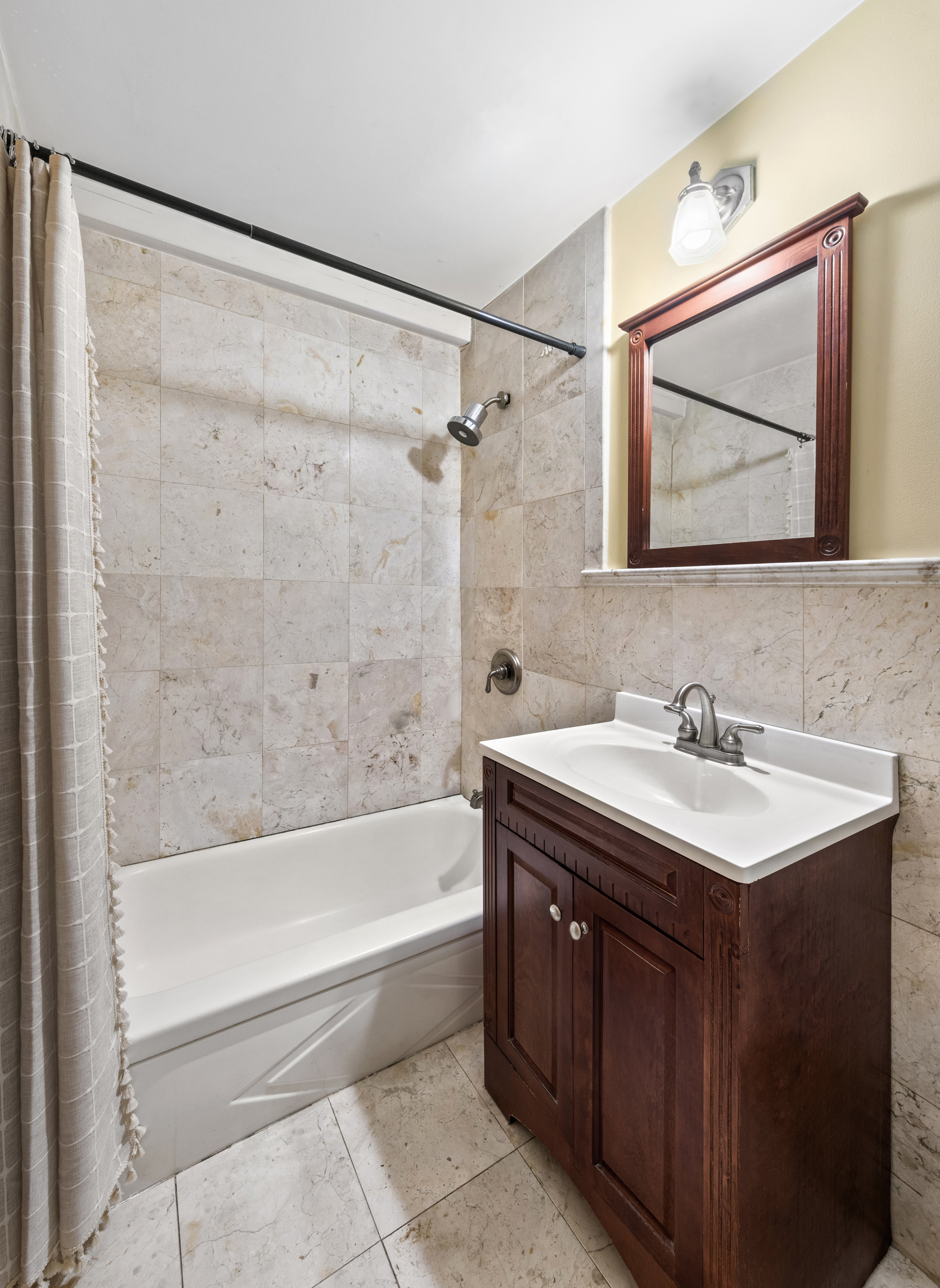 141 Sullivan Street, Unit G4 Manhattan, NY 10012 - Photo 4 of 6 a bathroom with a tub sink and mirror