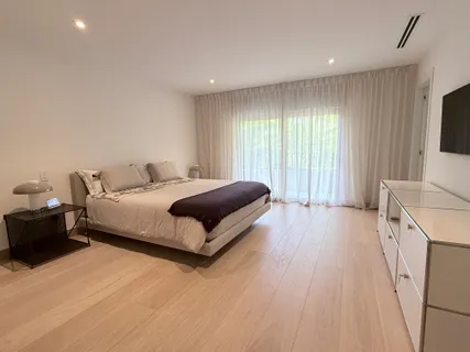 a bedroom with a bed and a large window