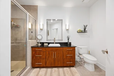 a bathroom with a toilet a sink and mirror