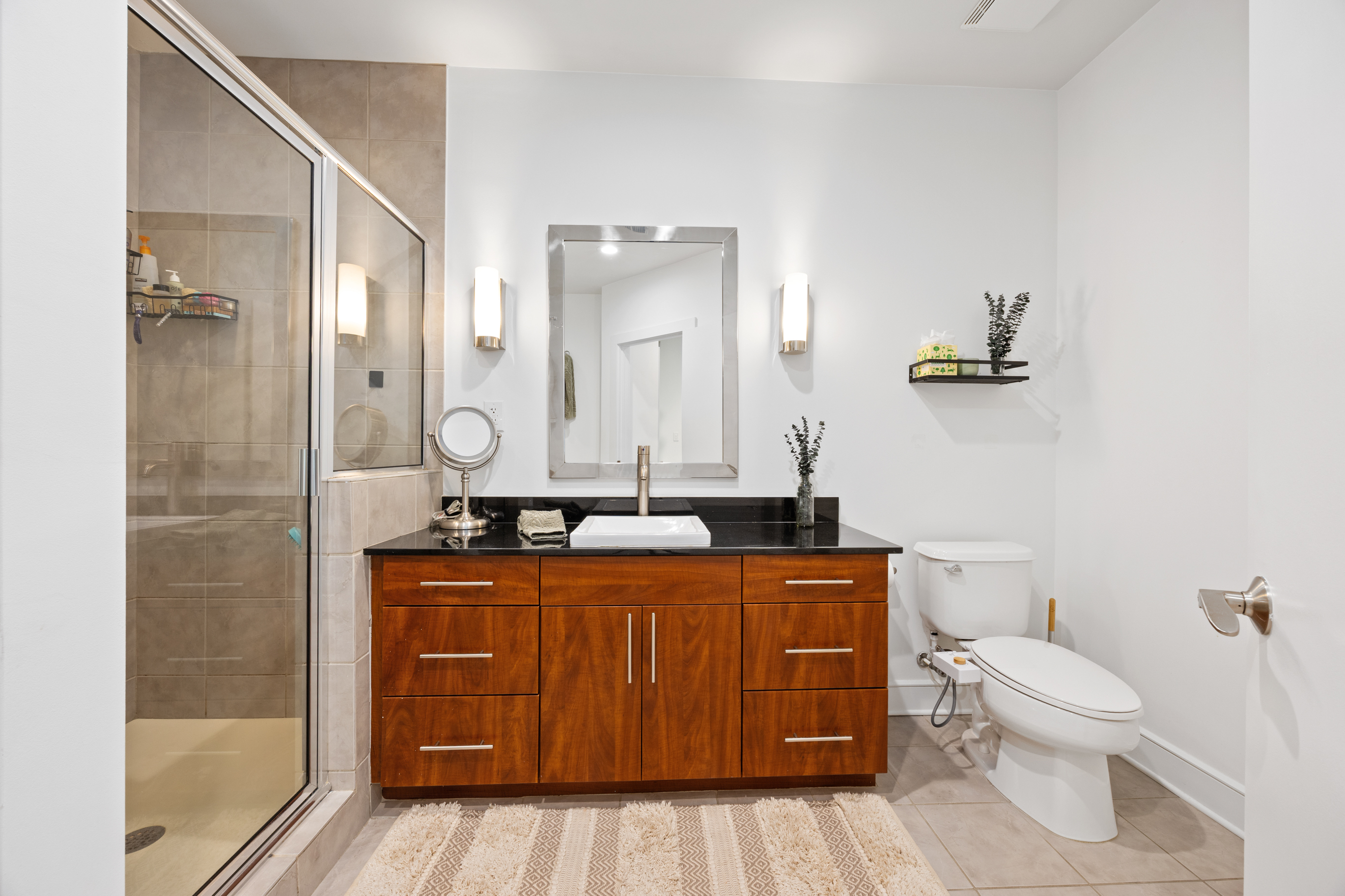 222 12th Street Northeast Atlanta, GA 30309 - Photo 21 of 56 a bathroom with a toilet a sink and mirror