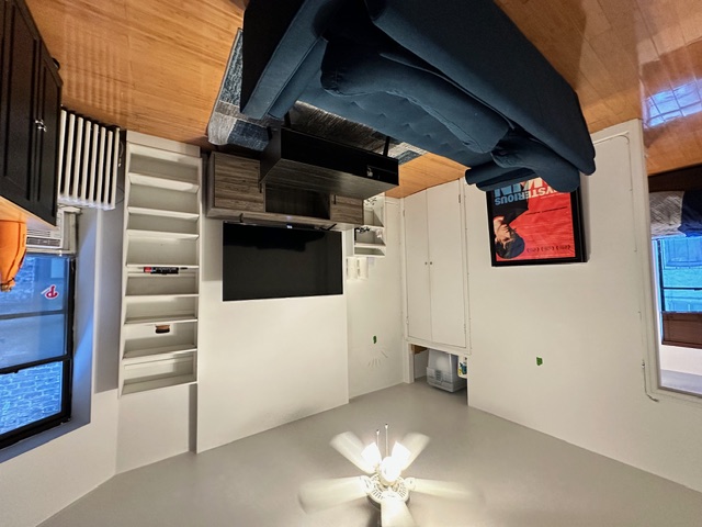 349 West 45th Street, Unit 3RE Manhattan, NY 10036 - Photo 2 of 5 a living room with furniture and a flat screen tv