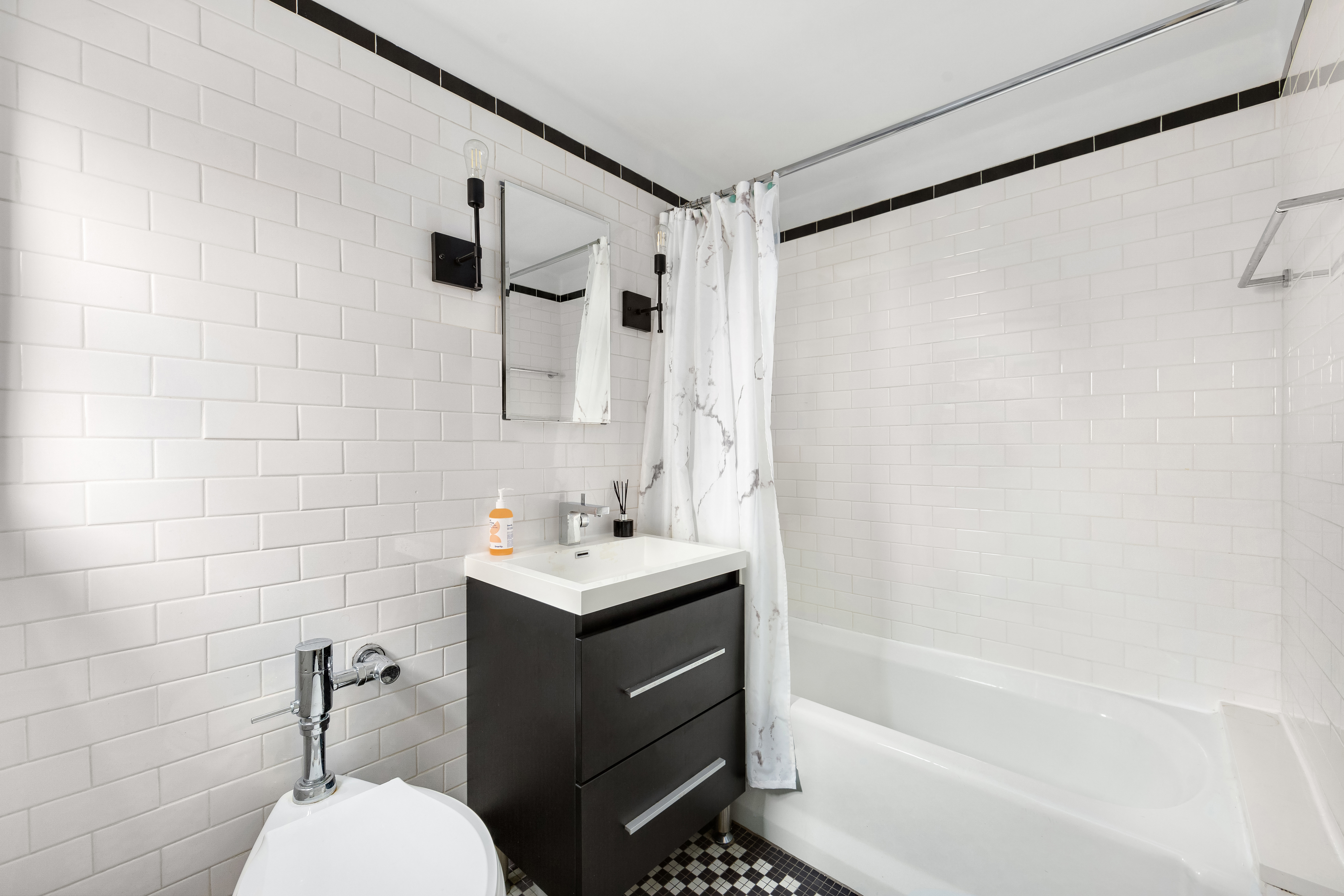 470 West 24th Street, Unit 2C Manhattan, NY 10011 - Photo 10 of 15 a bathroom with a sink toilet and shower