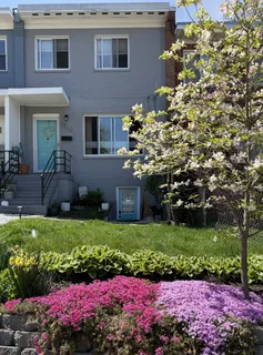 a front view of a house with a yard and fountain