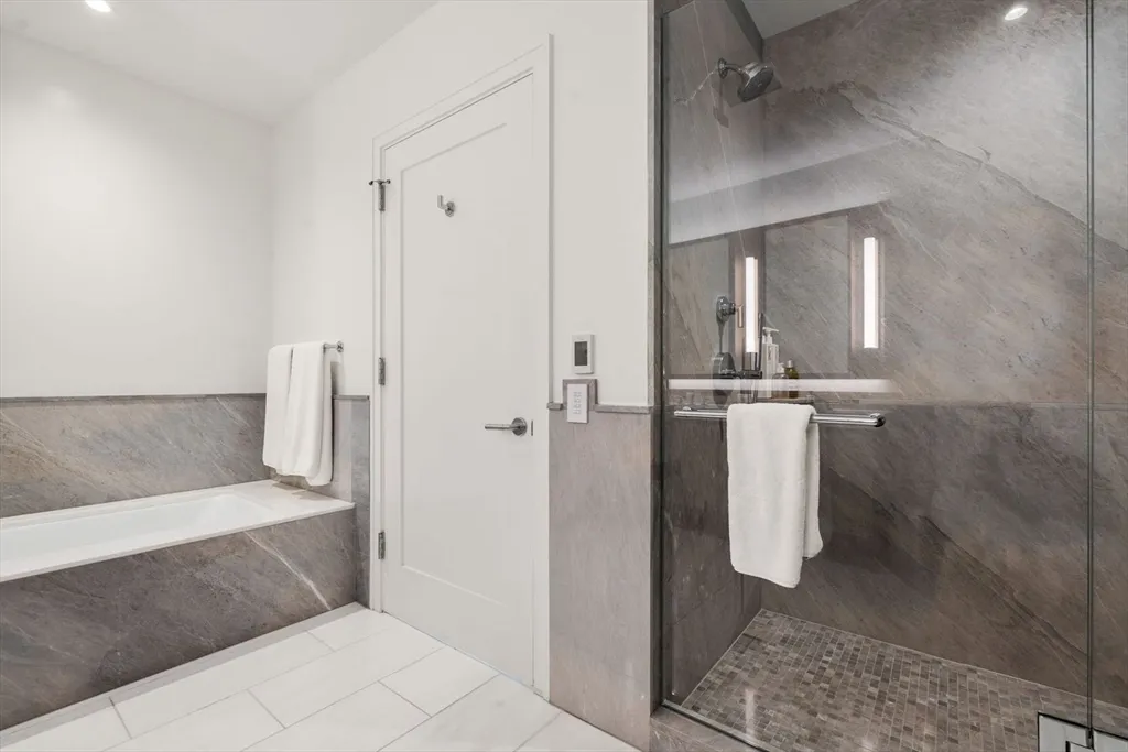 a bathroom with a bathtub and shower