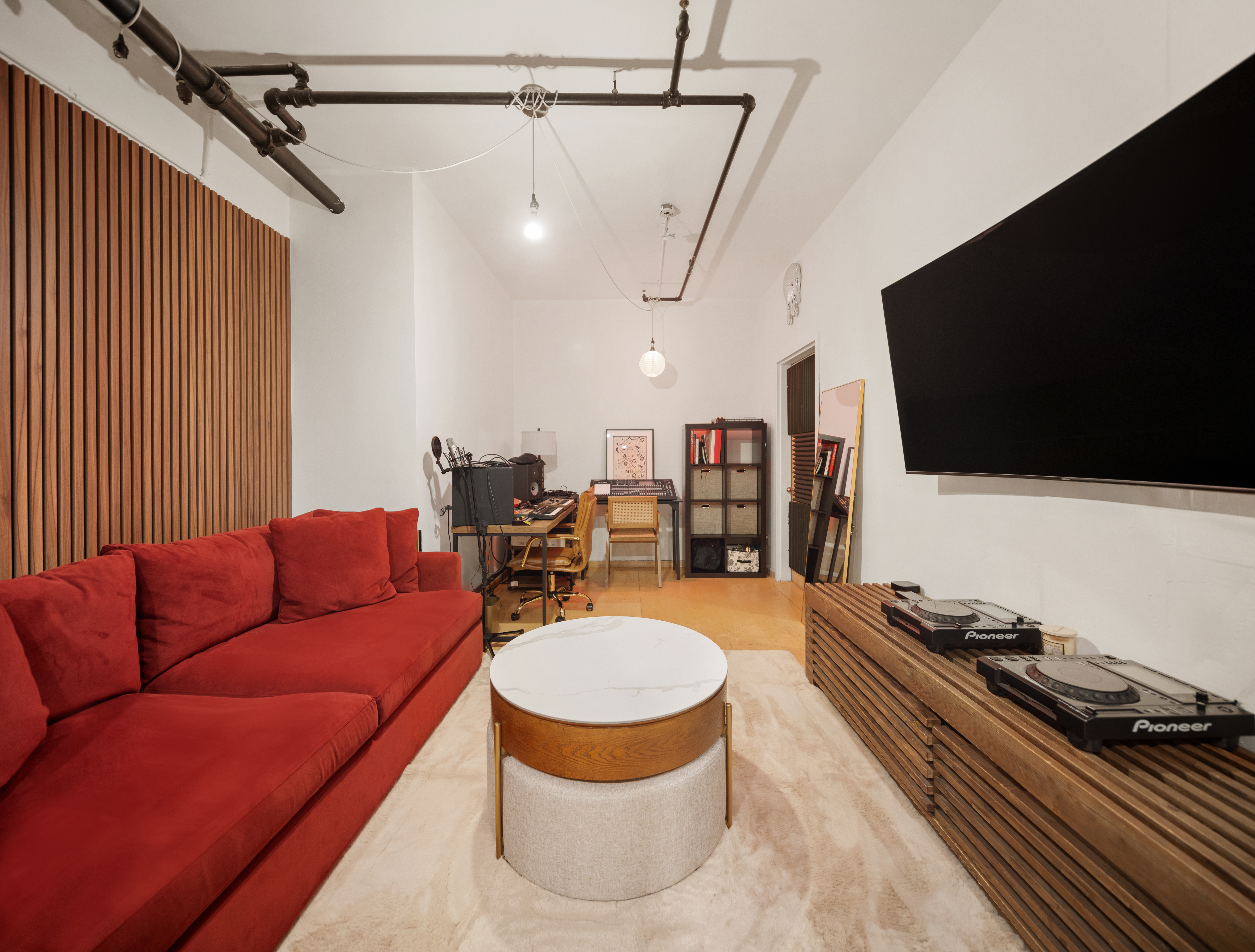 138 Broadway, Unit 1D Brooklyn, NY 11211 - Photo 8 of 9 a living room with furniture and a flat screen tv