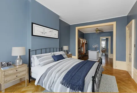 a bedroom with a bed and a lamp on table