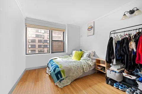 a bedroom with bed and a window