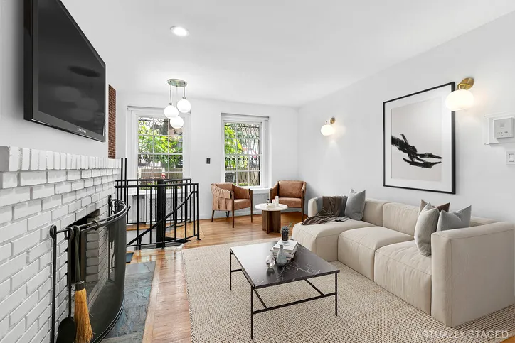a living room with fireplace furniture and a flat screen tv
