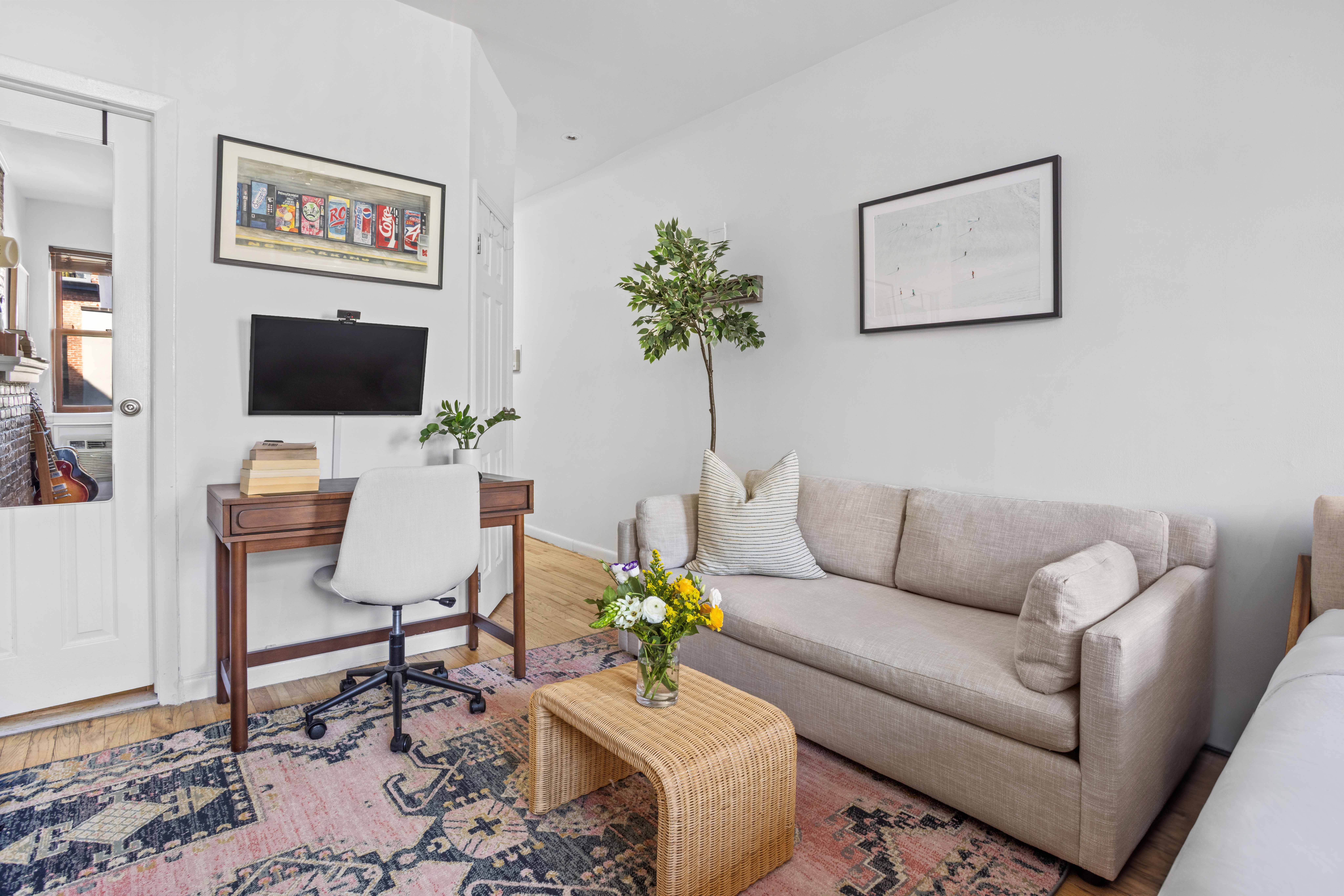 335 West 21st Street, Unit 3RE Manhattan, NY 10011 - Photo 3 of 7 a living room with furniture a couch and a potted plant