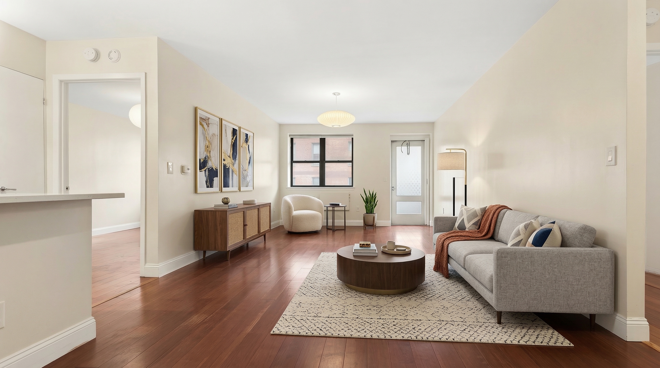1919 Madison Avenue, Unit 418 Manhattan, NY 10035 - Photo 1 of 16 a living room with furniture and a wooden floor