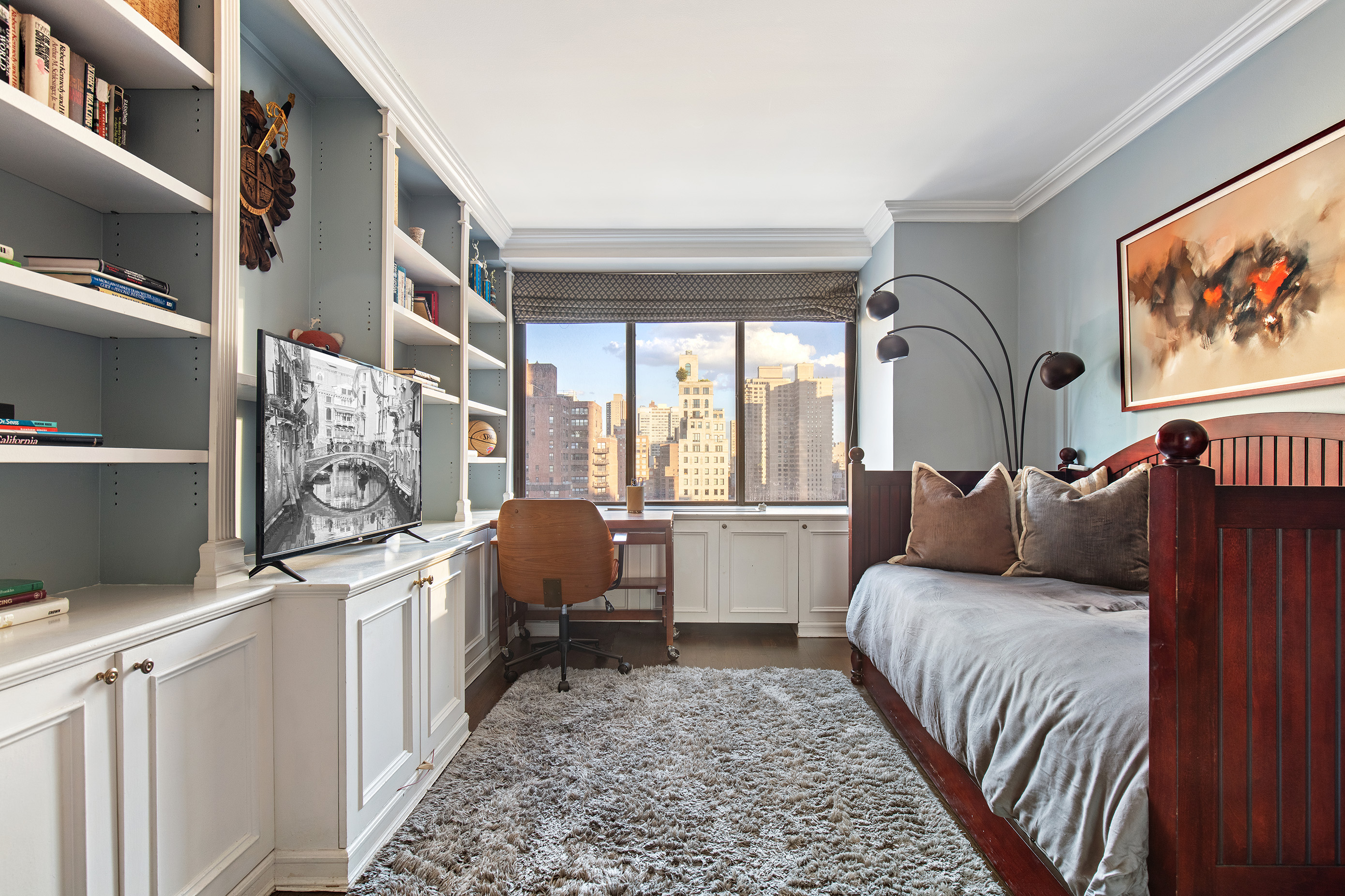 1441 3rd Avenue, Unit 14AB Manhattan, NY 10028 - Photo 7 of 16 a bed room with a bed and a couch