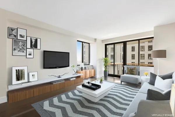 a living room with furniture a flat screen tv and a floor to ceiling window