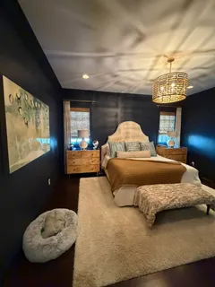 a bedroom with a bed mirror and window
