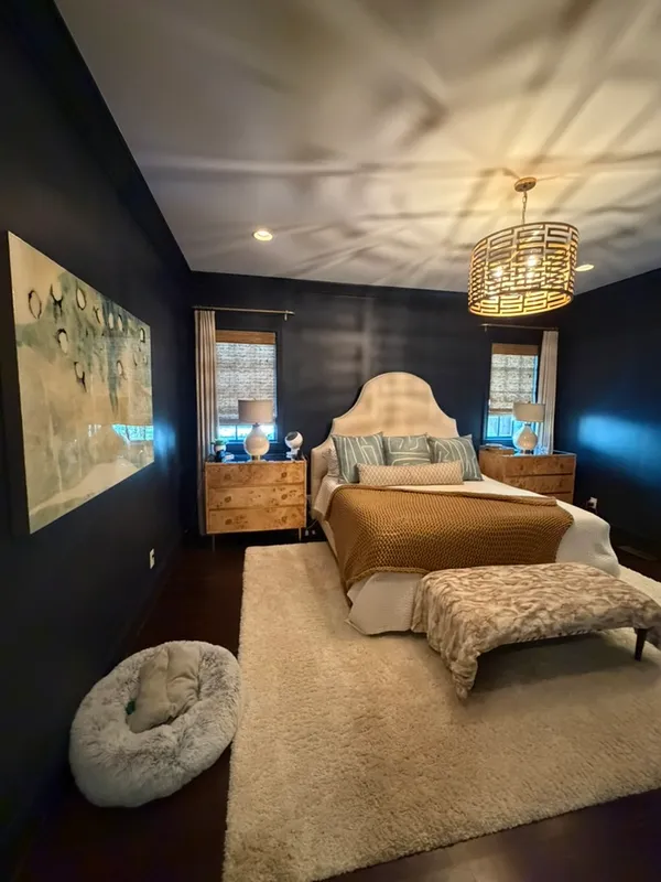 a bedroom with a bed mirror and window