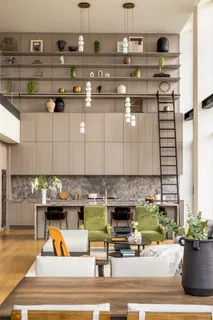 a living room with furniture and large windows