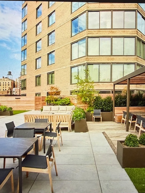 40 East 94th Street, Unit 6F Manhattan, NY 10128 - Photo 15 of 17 a view of a building and outdoor seating