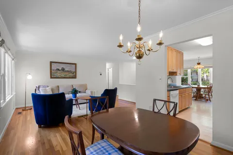 a view of a dining room with furniture and chandelier