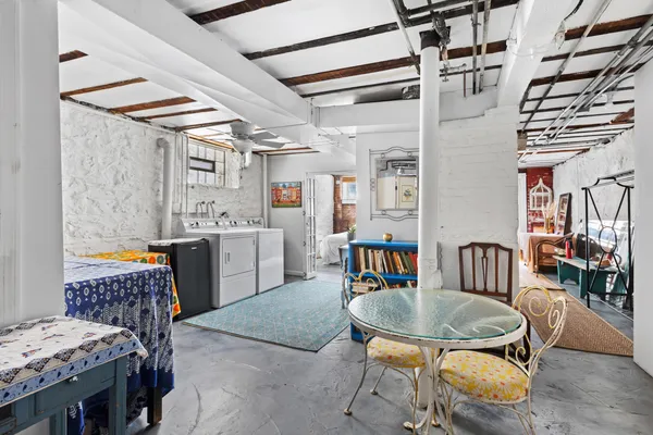 a dining room with furniture and a floor to ceiling window