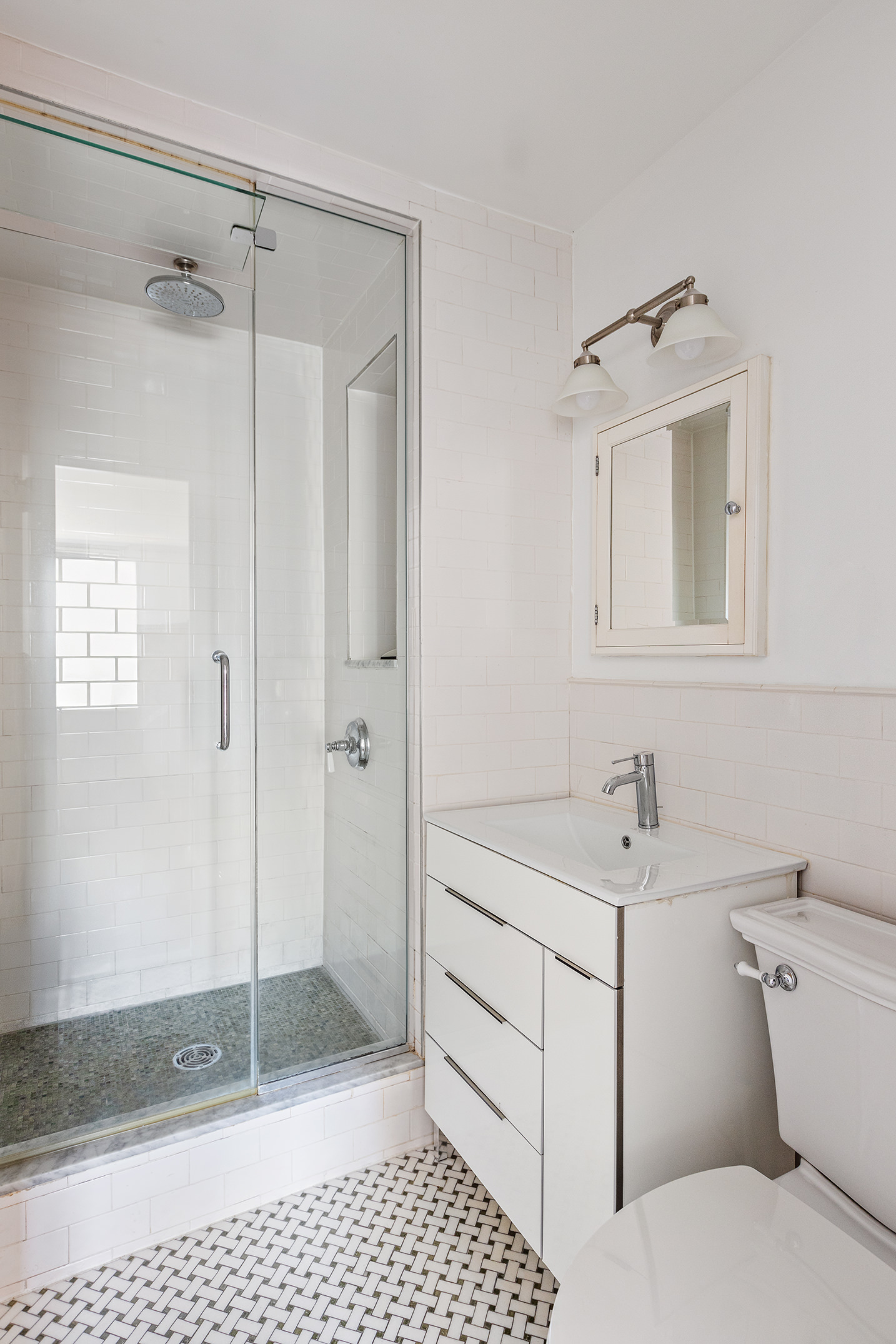 1619 3rd Avenue, Unit 21H Manhattan, NY 10128 - Photo 6 of 16 a bathroom with a sink a toilet and shower