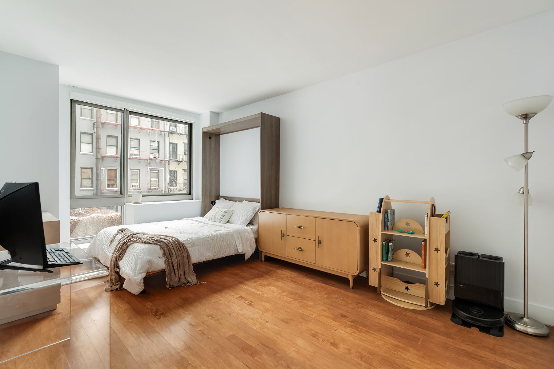 242 East 25th Street, Unit 3A Manhattan, NY 10010 - Photo 5 of 9 a bed room with a bed and a tv