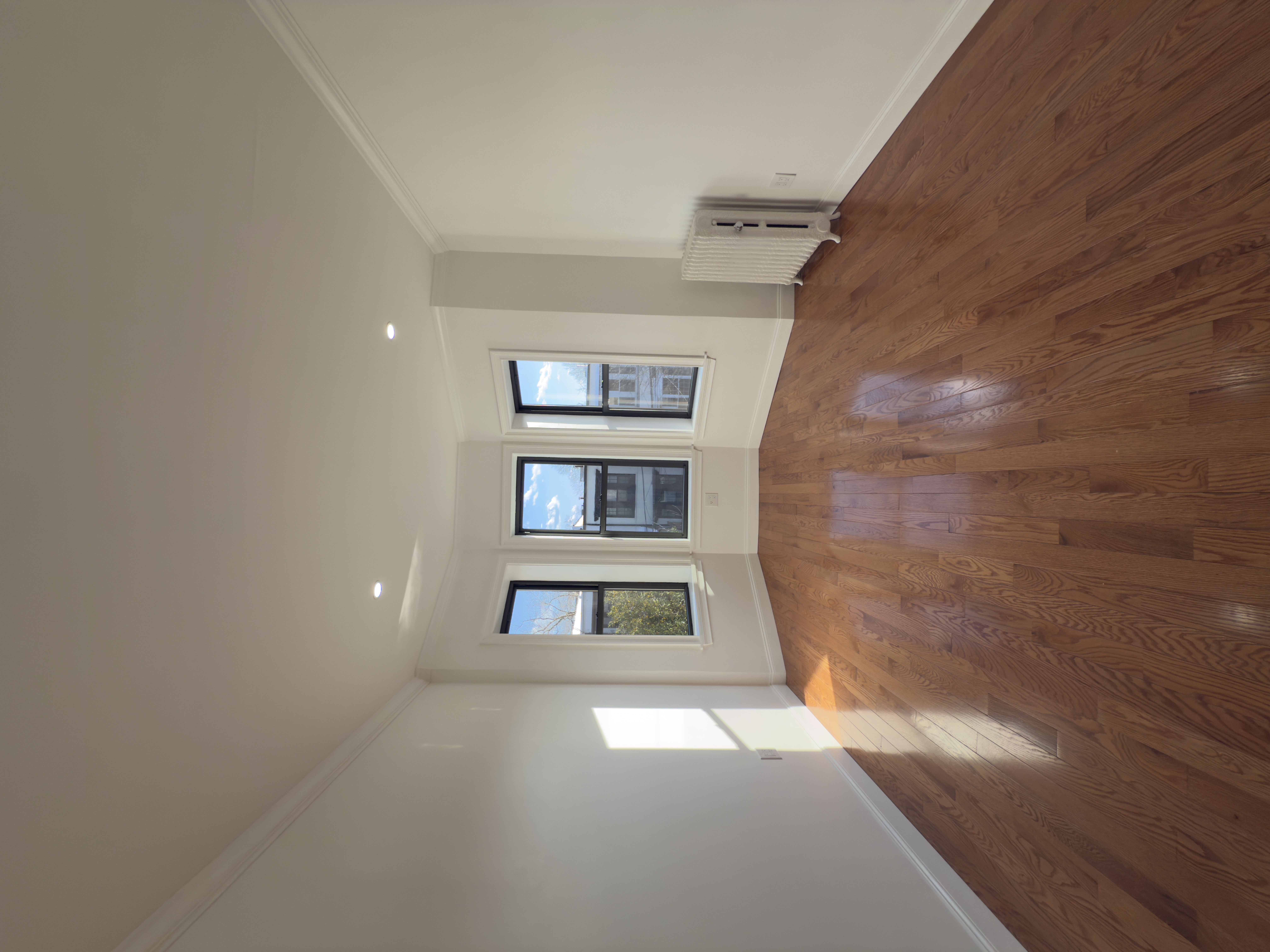 82 74th Street Brooklyn, NY 11209 - Photo 15 of 21 a view of an empty room with wooden floor and window