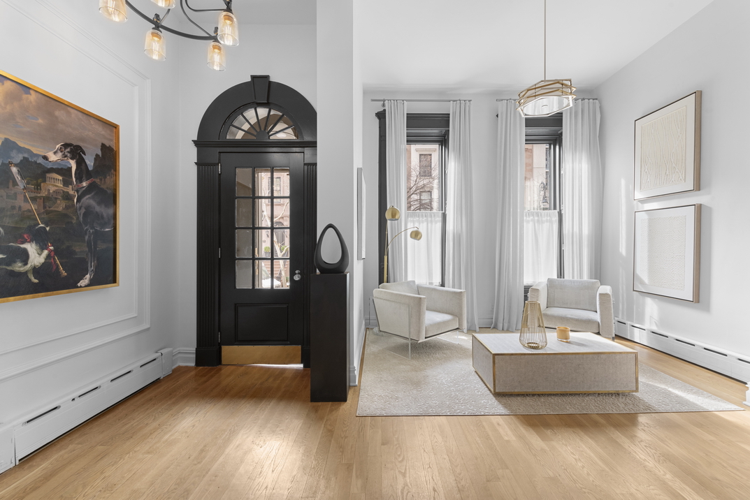209 East 61st Street Manhattan, NY 10065 - Photo 5 of 24 a living room with furniture and a fireplace