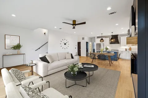 a living room with furniture and kitchen view