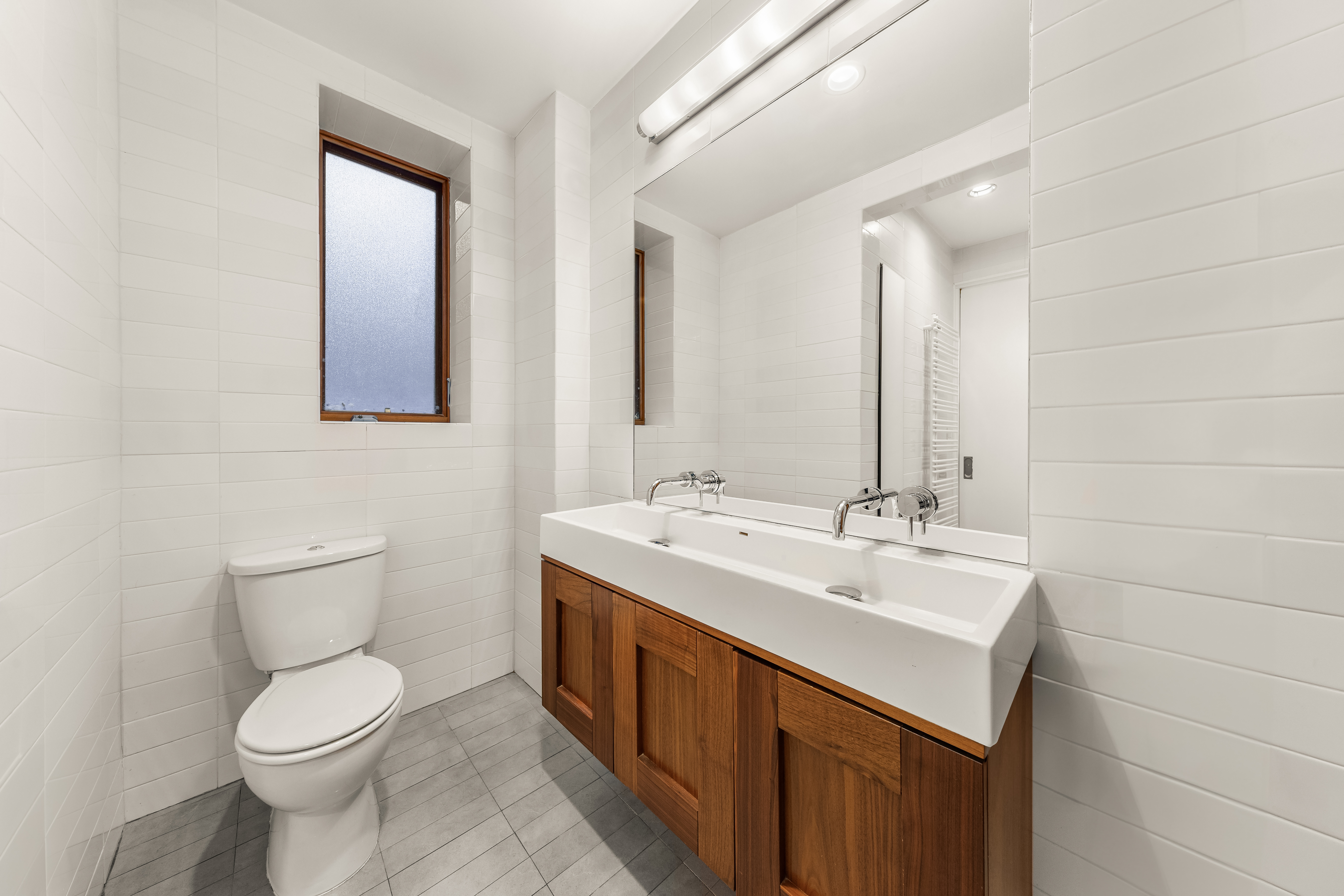 7 West 92nd Street, Unit 76 Manhattan, NY 10025 - Photo 7 of 11 a bathroom with a toilet sink and mirror
