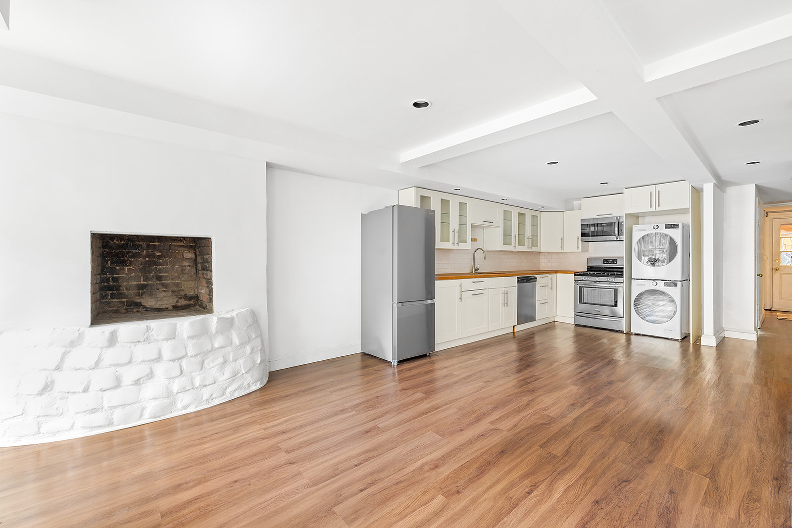 166 Congress Street, Unit A Brooklyn, NY 11201 - Photo 2 of 9 a kitchen with stainless steel appliances wooden floor and view living room