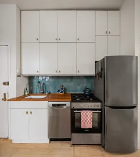 a kitchen with stainless steel appliances granite countertop a refrigerator and a stove