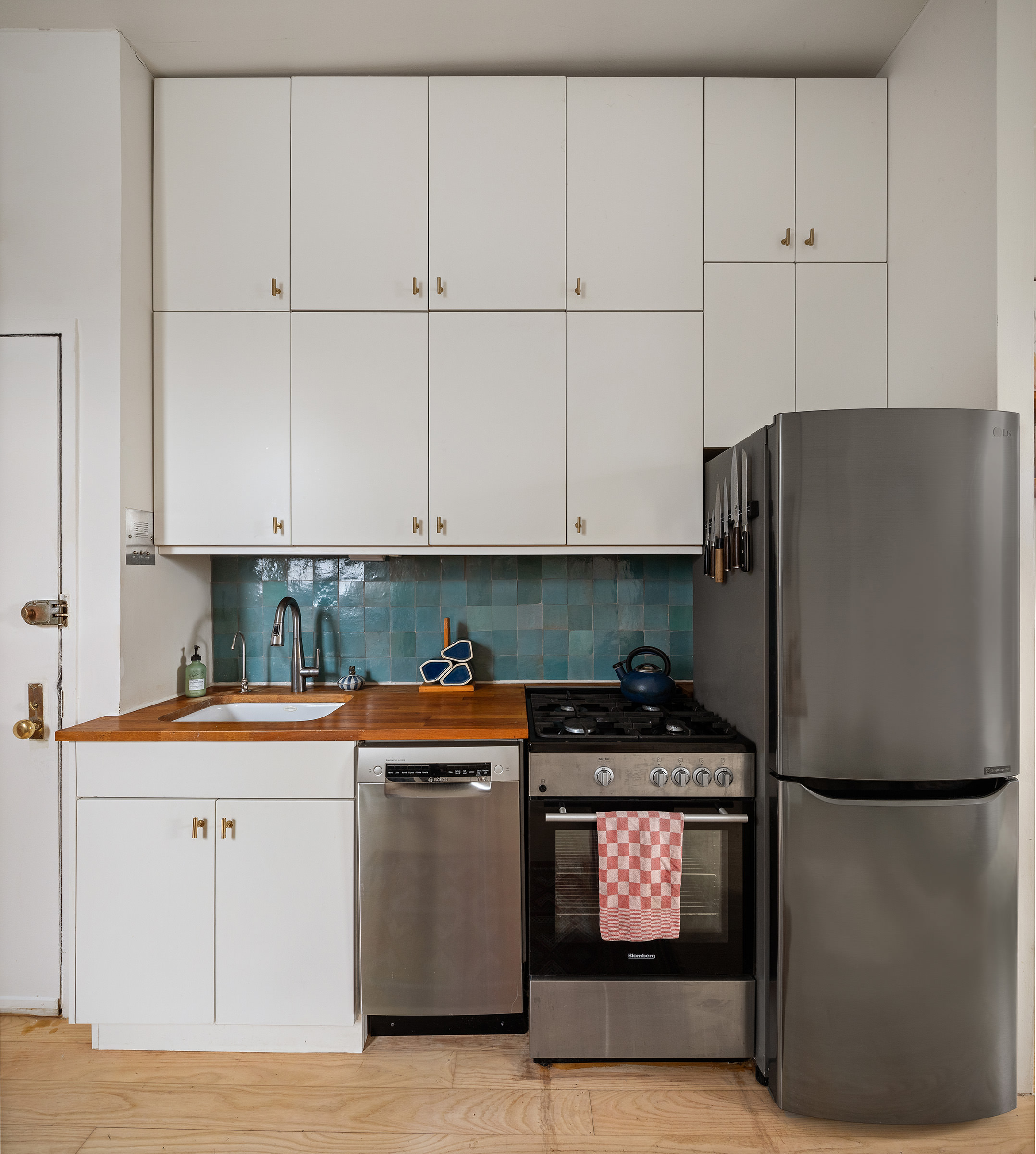 633 East 11th Street, Unit 22 Manhattan, NY 10009 - Photo 3 of 10 a kitchen with stainless steel appliances granite countertop a refrigerator and a stove