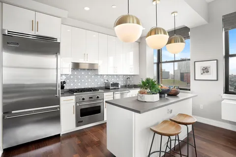 a kitchen with a refrigerator and a stove