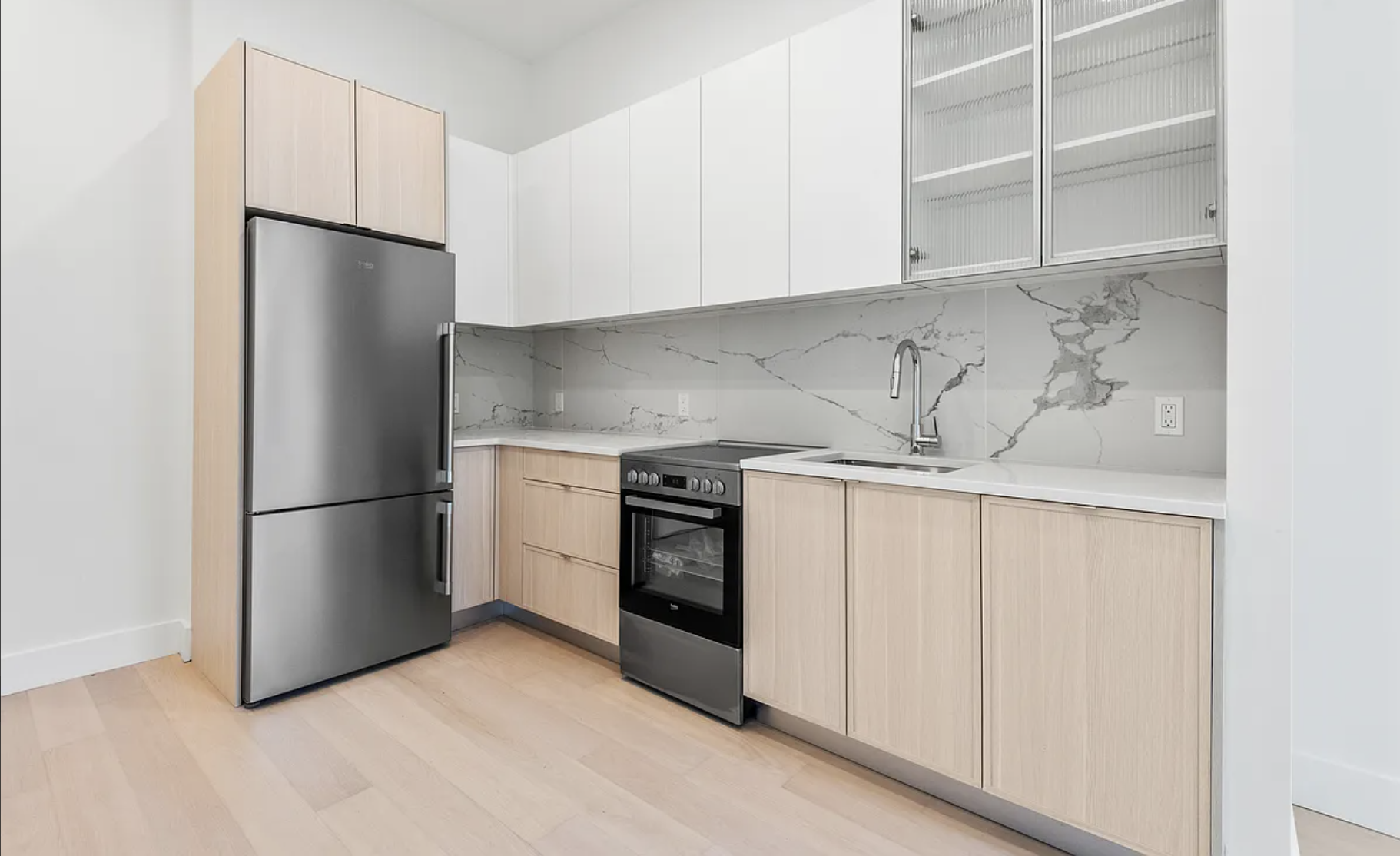 218 Front Street, Unit 184 Brooklyn, NY 11201 - Photo 3 of 13 a kitchen with stainless steel appliances white cabinets and a refrigerator