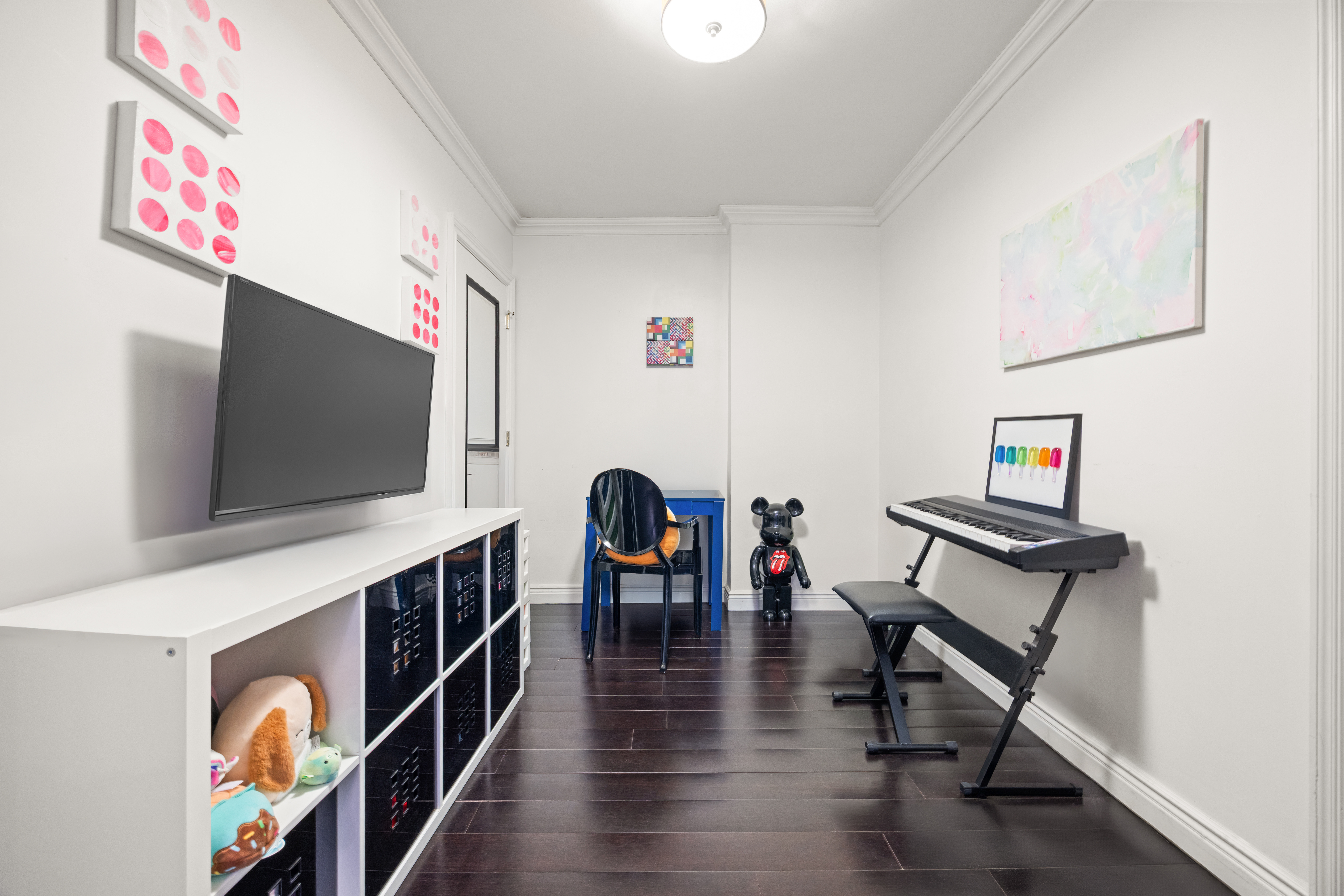 136 East 56th Street, Unit 10JK Manhattan, NY 10022 - Photo 8 of 12 a living room with furniture and a flat screen tv