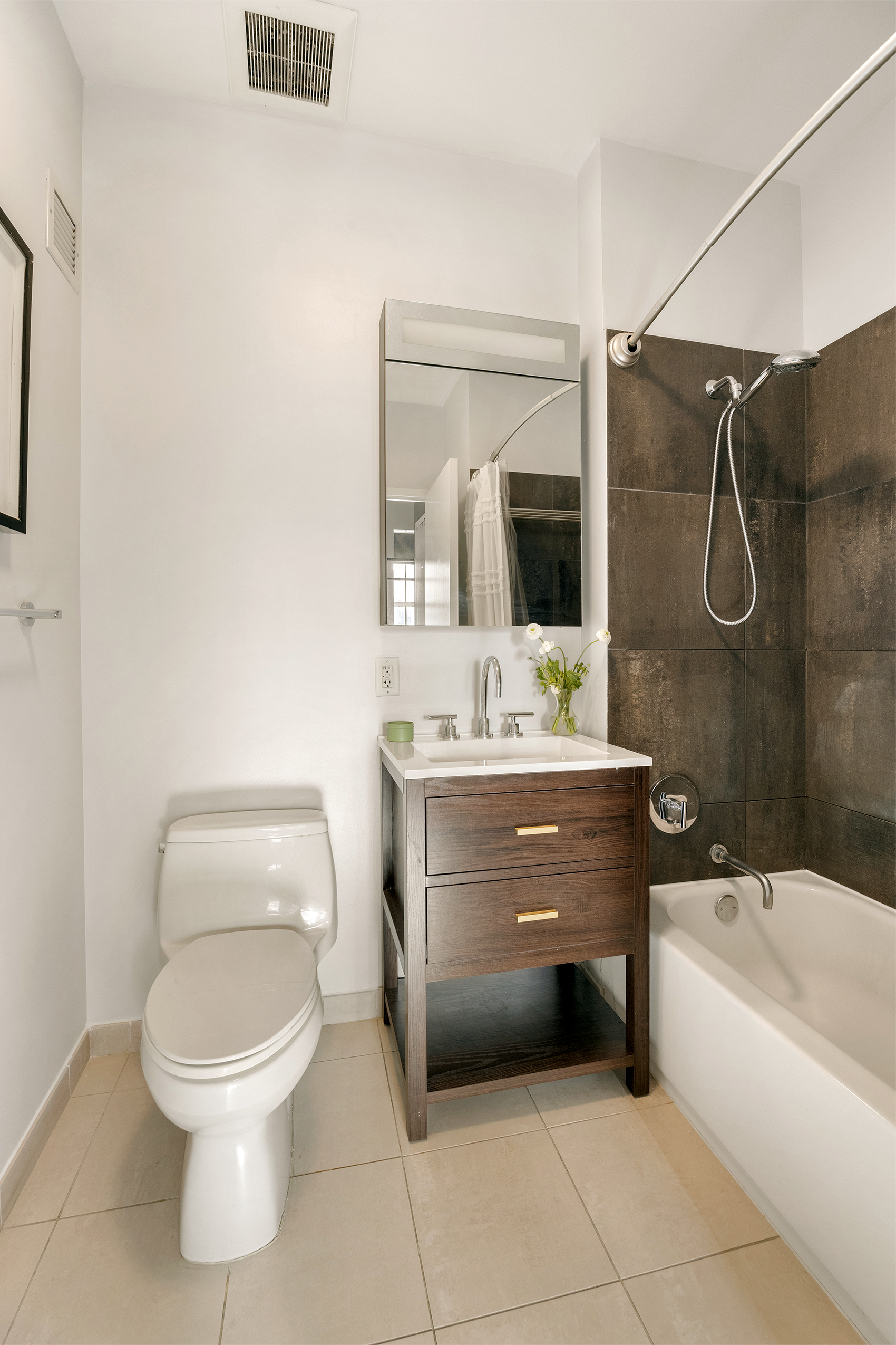 184 Kent Avenue, Unit B305 Brooklyn, NY 11249 - Photo 7 of 15 a bathroom with a sink a toilet and shower
