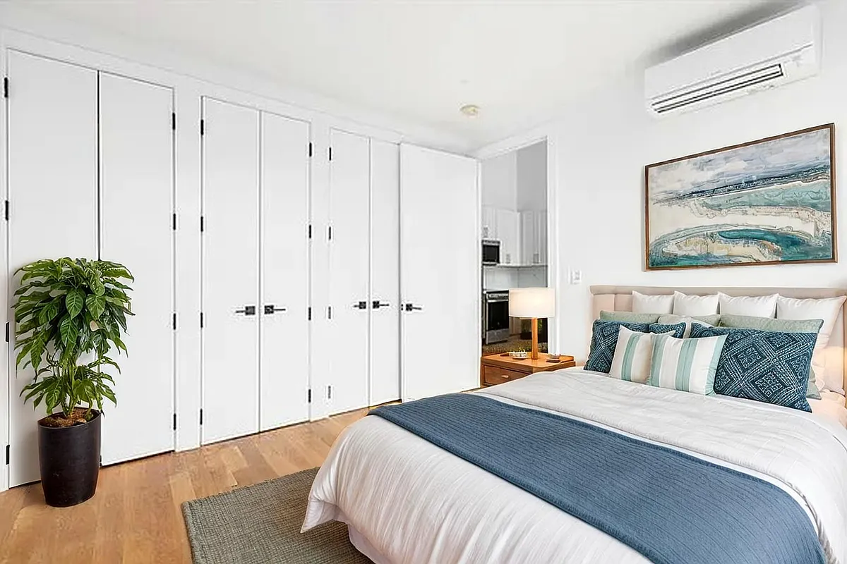 212 Malcolm X Boulevard, Unit 4B Brooklyn, NY 11221 - Photo 4 of 5 a spacious bedroom with a bed and a potted plant