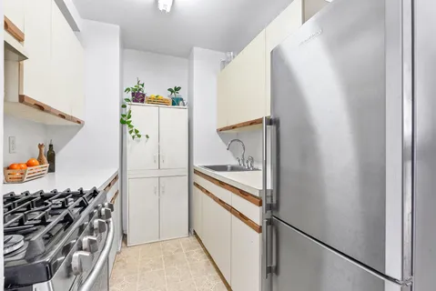 a kitchen with a refrigerator and a stove