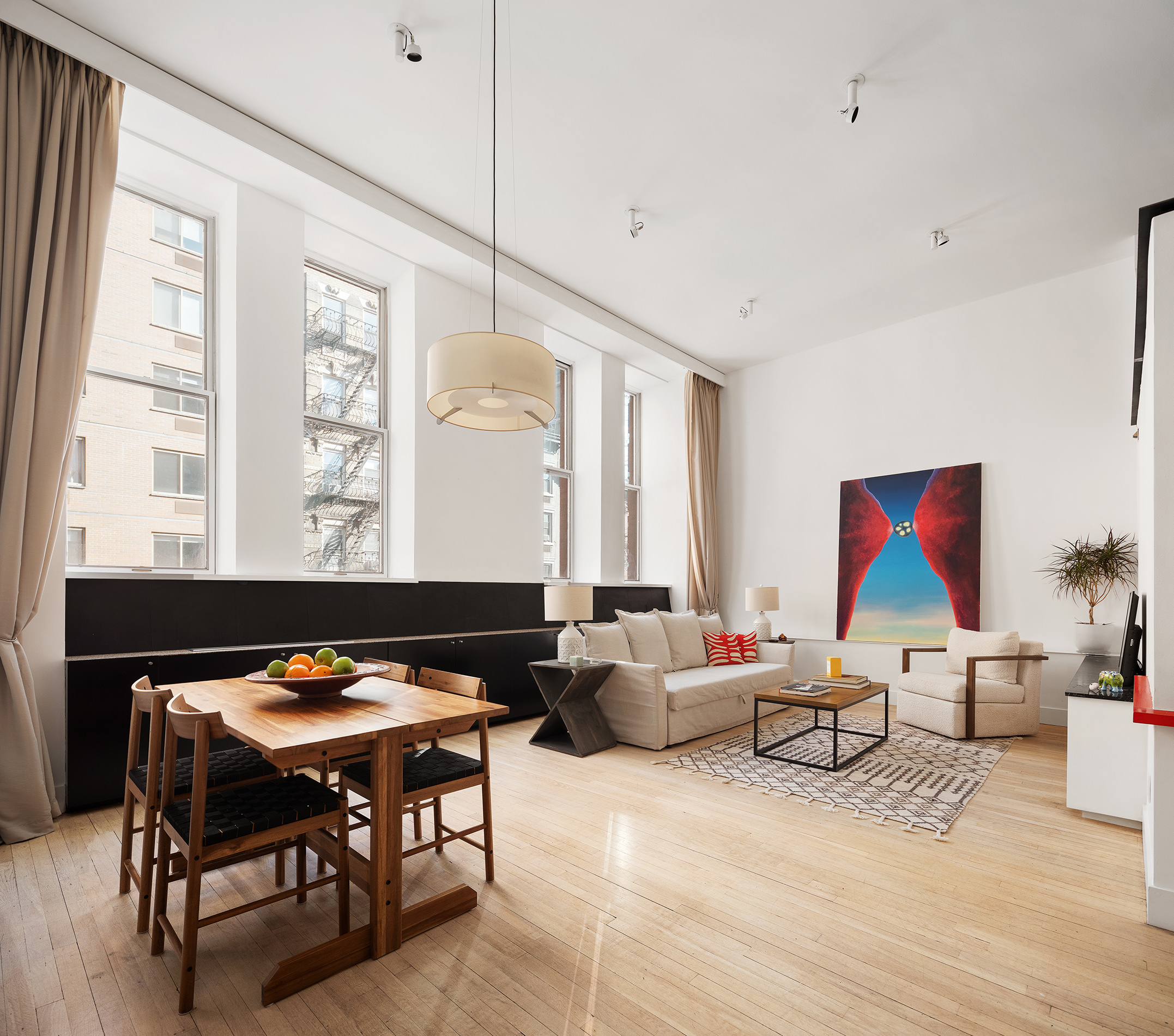 a living room with furniture a rug and a large window
