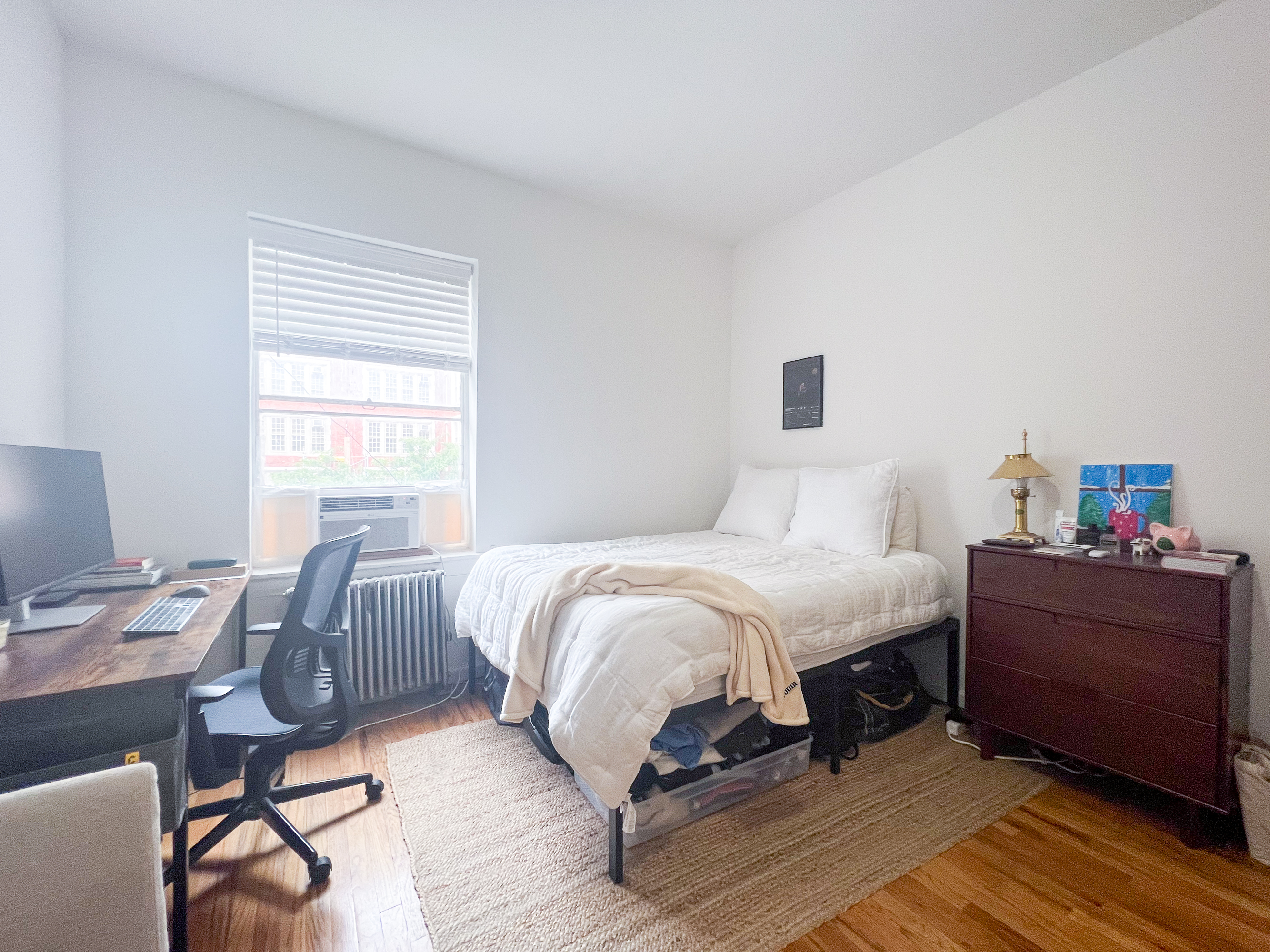 320 West 20th Street, Unit 14 Manhattan, NY 10011 - Photo 2 of 13 a bedroom with a bed and wooden floor