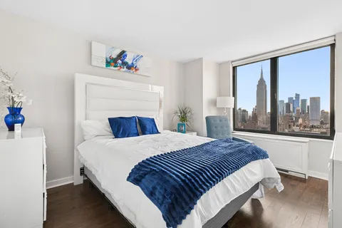 a bedroom with a large bed and a large window