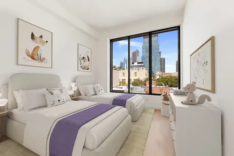 a bedroom with a large bed and a large window