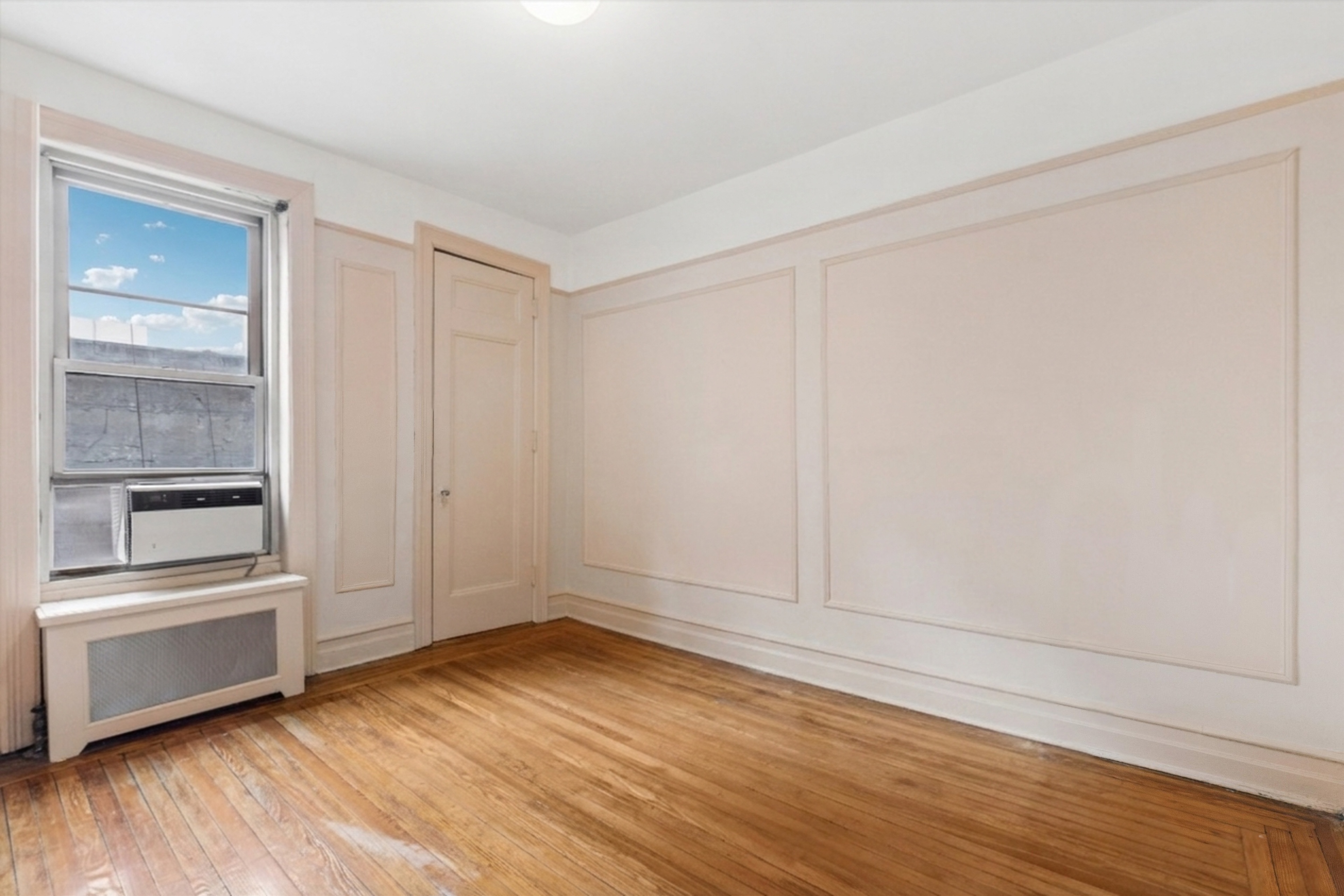 17 East 97th Street, Unit 5A Manhattan, NY 10029 - Photo 17 of 25 a view of empty room with wooden floor and fan