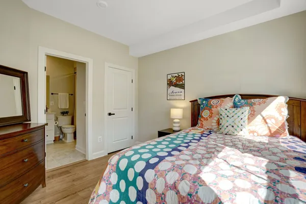 a bedroom with a large bed and a dresser