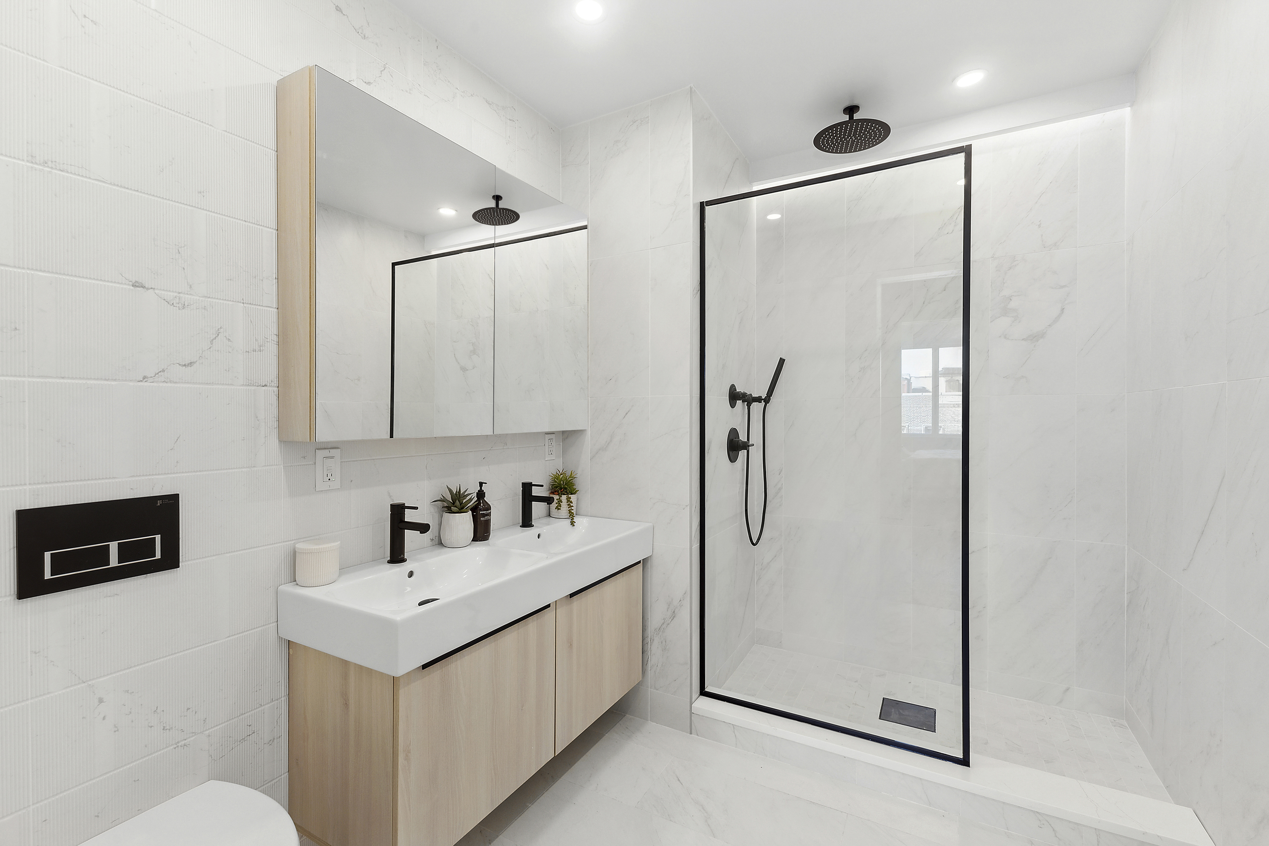 12-16 30th Avenue, Unit 201 Queens, NY 11102 - Photo 8 of 18 a bathroom with a sink a double vanity and a mirror