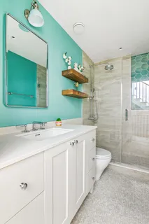 a bathroom with a double vanity sink mirror and toilet