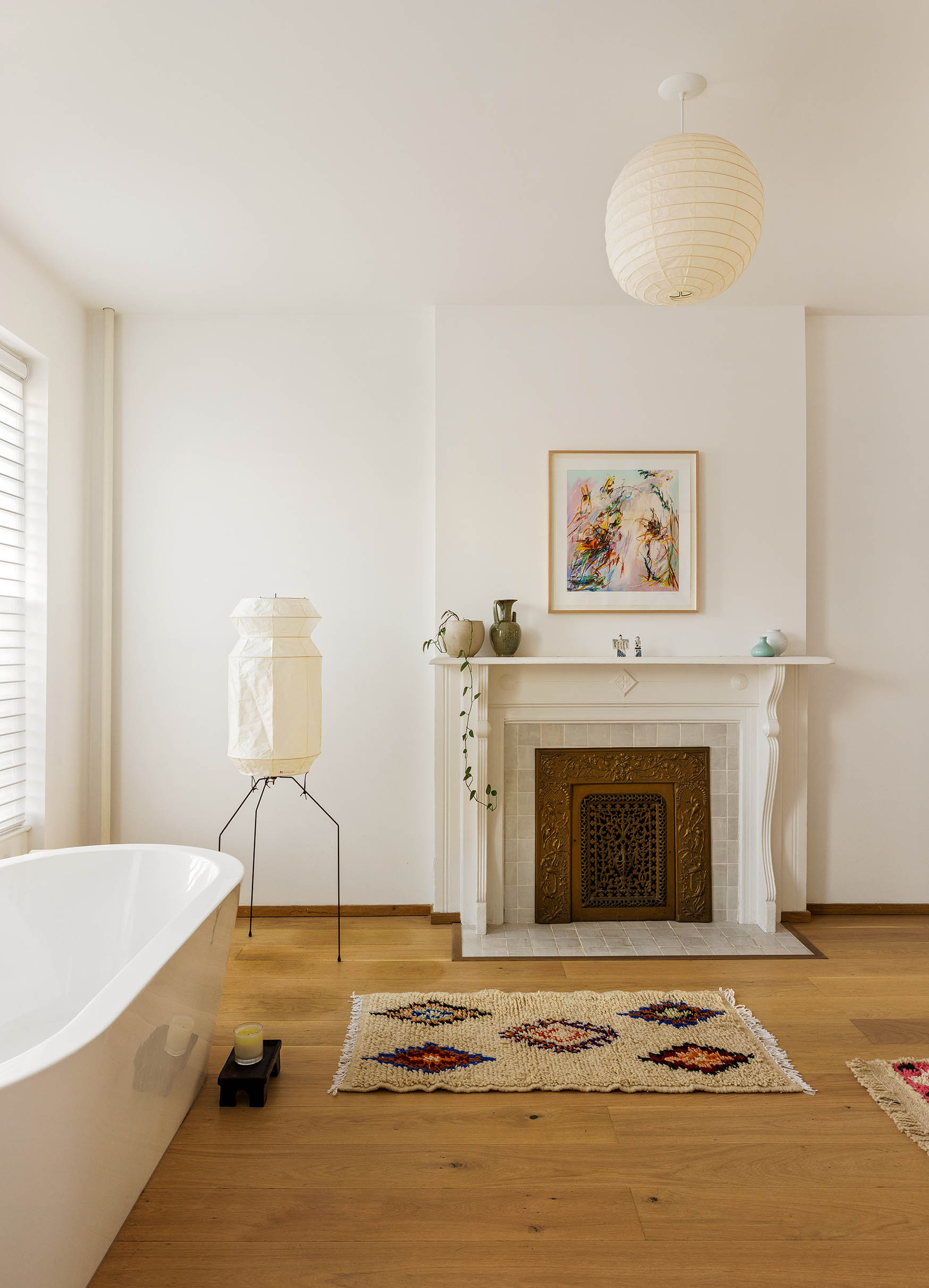 679 Putnam Avenue Brooklyn, NY 11221 - Photo 11 of 27 a spacious bedroom with a fireplace and a chandelier