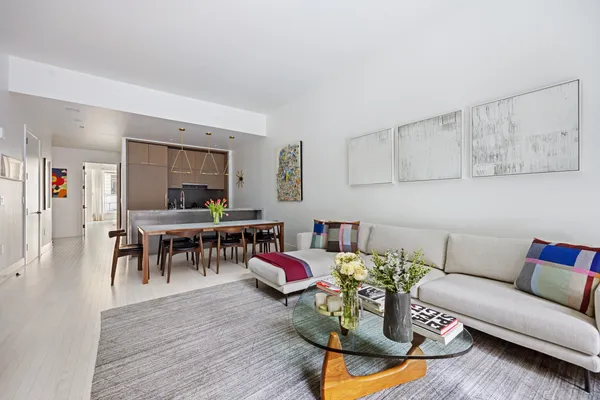 a living room with furniture and wooden floor