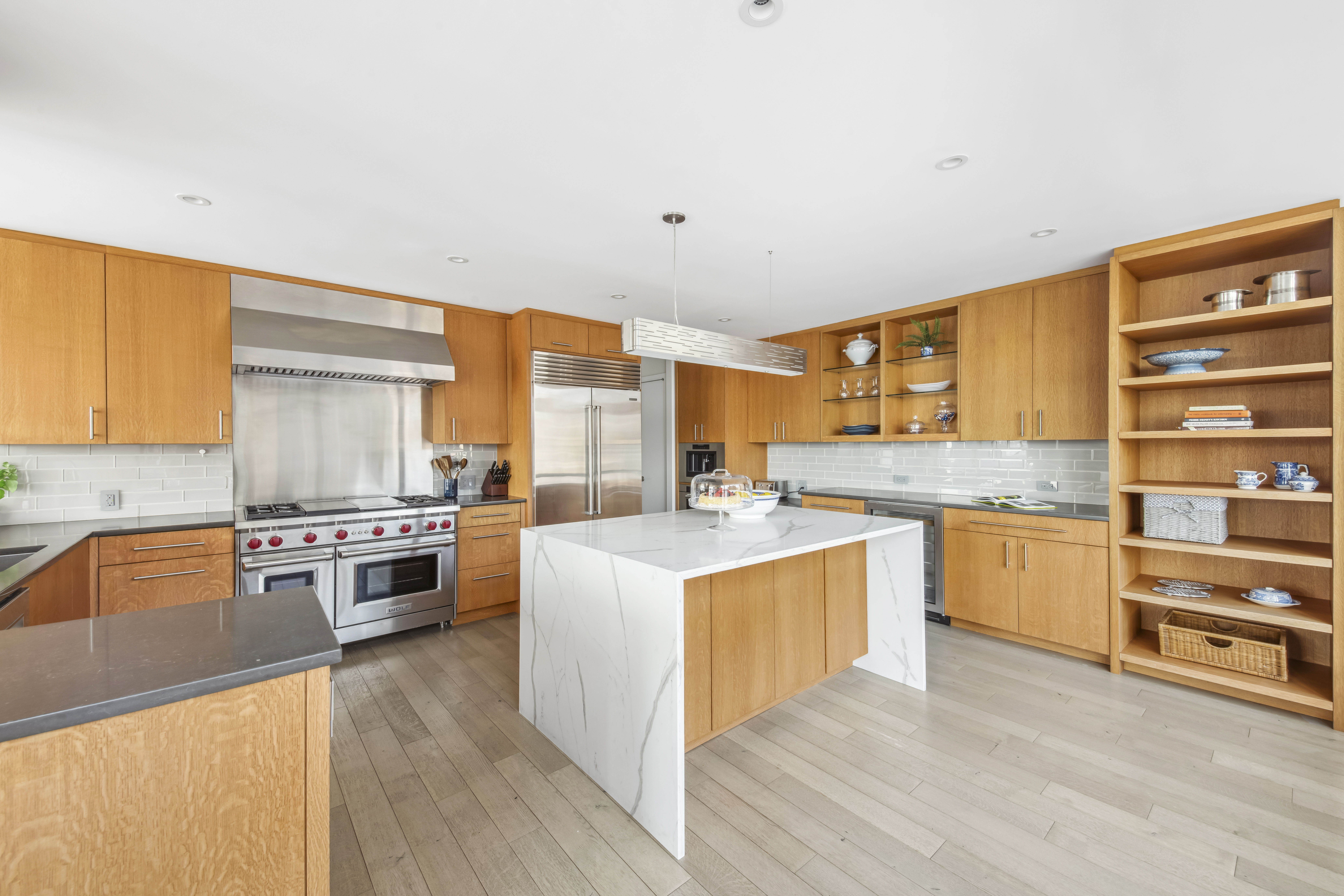 870 United Nations Plaza, Unit 15E Manhattan, NY 10017 - Photo 12 of 19 a kitchen with stainless steel appliances granite countertop a stove top oven and sink